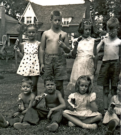 An ice-cream break on a hot summer day. (top row from left -- Jean Wrigley, Doug Stride, Bev Stride, unknown fellow; seated row from left, John Wrigley, Bob Wrigley, Judy Barber, Lindy Barber). (c. 1950)
